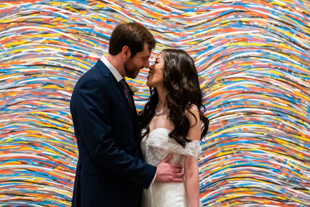 Bride & groom framed with the background of colorful modern art piece at Harvard Art Museum